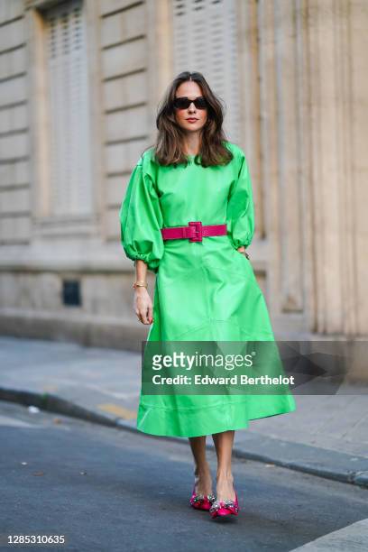 Therese Hellström wears a green leather dress with puff sleeves and a purple leather crocodile pattern belt from CCMINDOV, pink pointy bejeweled...