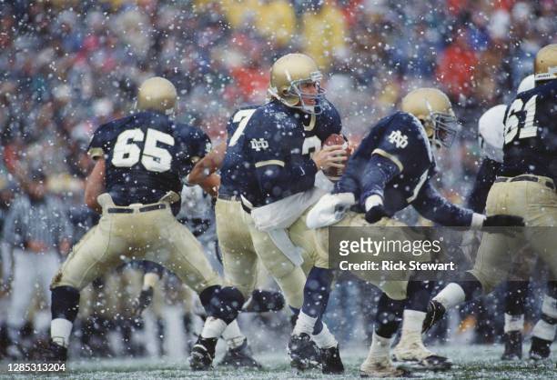 Rick Mirer, Quarterback for the University of Notre Dame Fighting Irish in motion as snow falls during the NCAA Independent college football game...