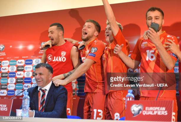 North Macedonia players Celebrate by pouring water over Igor Angelovski, Head Coach of North Macedonia as he speaks to the media in a press...