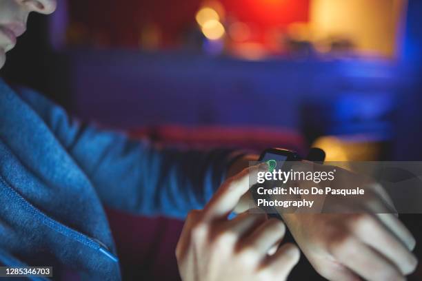 young woman using smartwatch - smart watch stock pictures, royalty-free photos & images