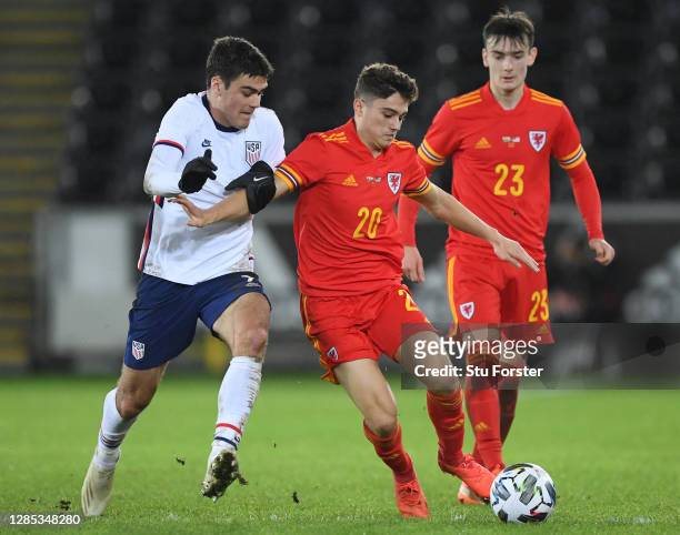 Daniel James of Wales is tackled by Giovanni Reyna of USA during the international friendly match between Wales and the USA at Liberty Stadium on...
