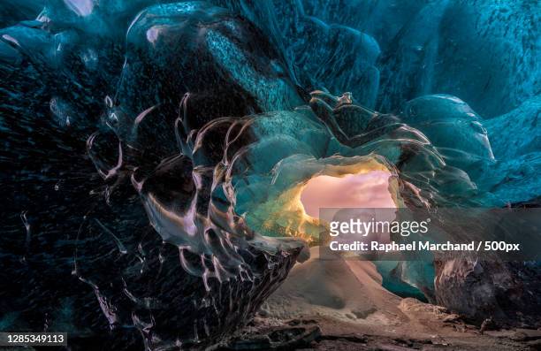 inside an ice cave looking out - marchand stock pictures, royalty-free photos & images