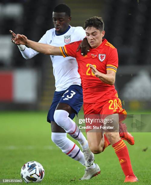 Daniel James of Wales is tackled by Timothy Weah of USA during the international friendly match between Wales and the USA at Liberty Stadium on...