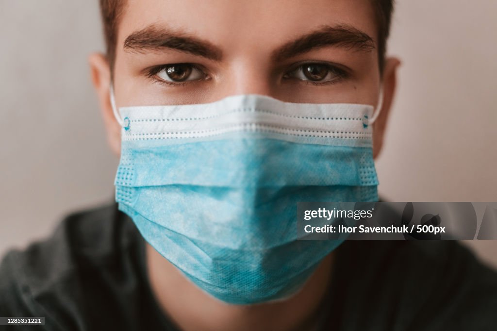 Portrait of a young man wearing a medical mask