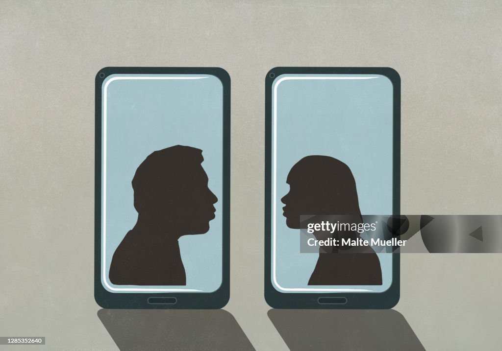 Silhouette couple kissing on separate smart phone screens