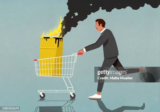 businessman pushing shopping cart with burning oil barrel - gasoline stock illustrations