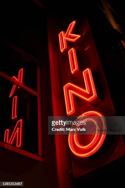 neon red movie theater sign, berlin, germany - cinema sign stock-fotos und bilder