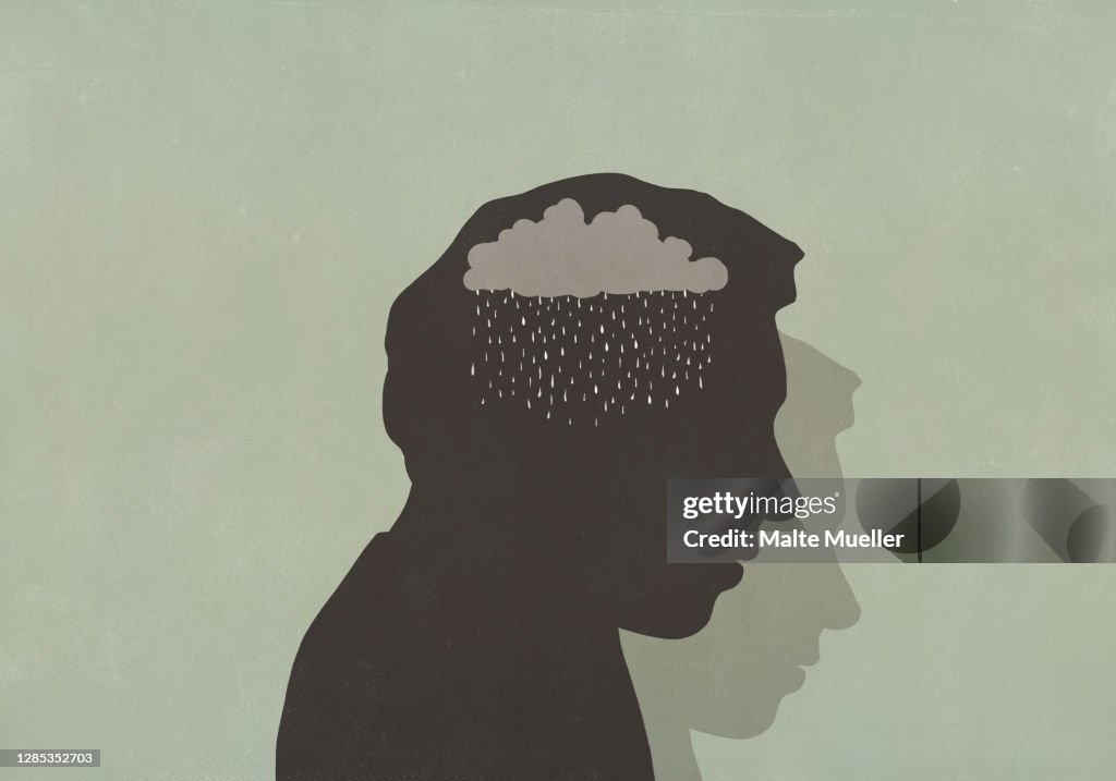 Silhouette of sad man with rain cloud in head