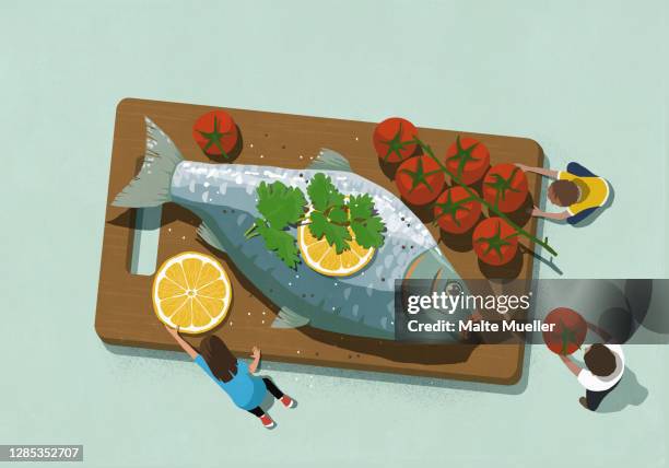family sharing large fish dinner with tomatoes - couple making dinner stock illustrations