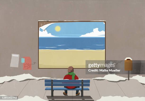 man on urban winter bench looking at sunny beach billboard - eskapismus stock-grafiken, -clipart, -cartoons und -symbole