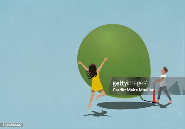illustrazioni stock, clip art, cartoni animati e icone di tendenza di happy man and woman inflating large balloon - giovane adulto