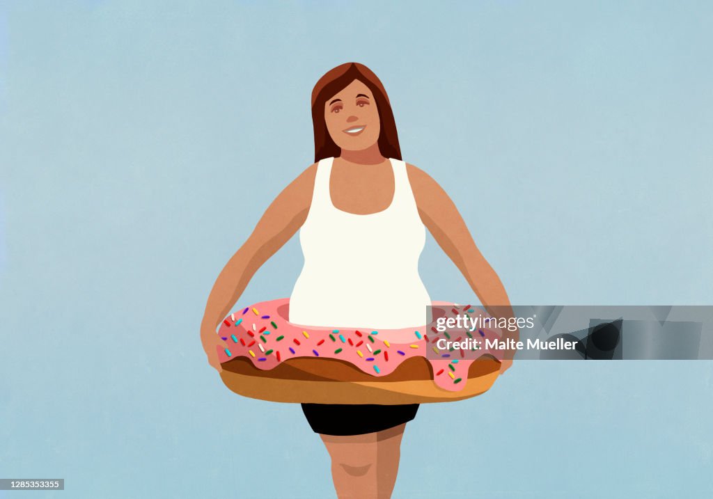 Portrait overweight woman wearing inflatable donut ring