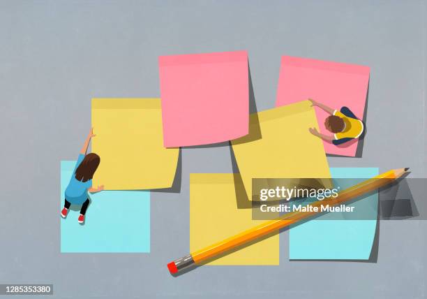 schoolchildren arranging large multicolor adhesive notes - klebezettel stock-grafiken, -clipart, -cartoons und -symbole