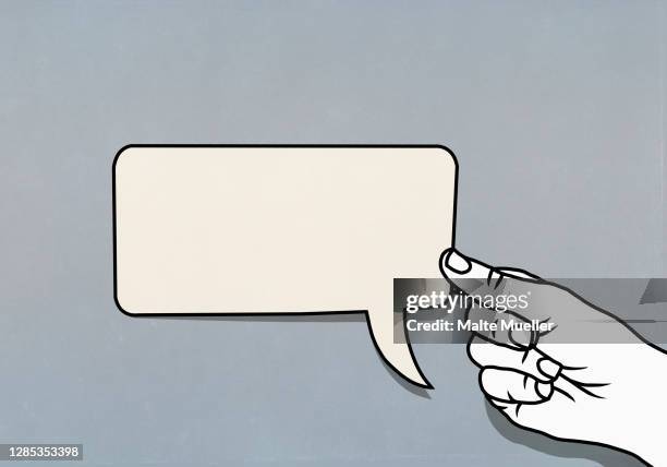 hand holding speech bubble adhesive note - pointer stock illustrations