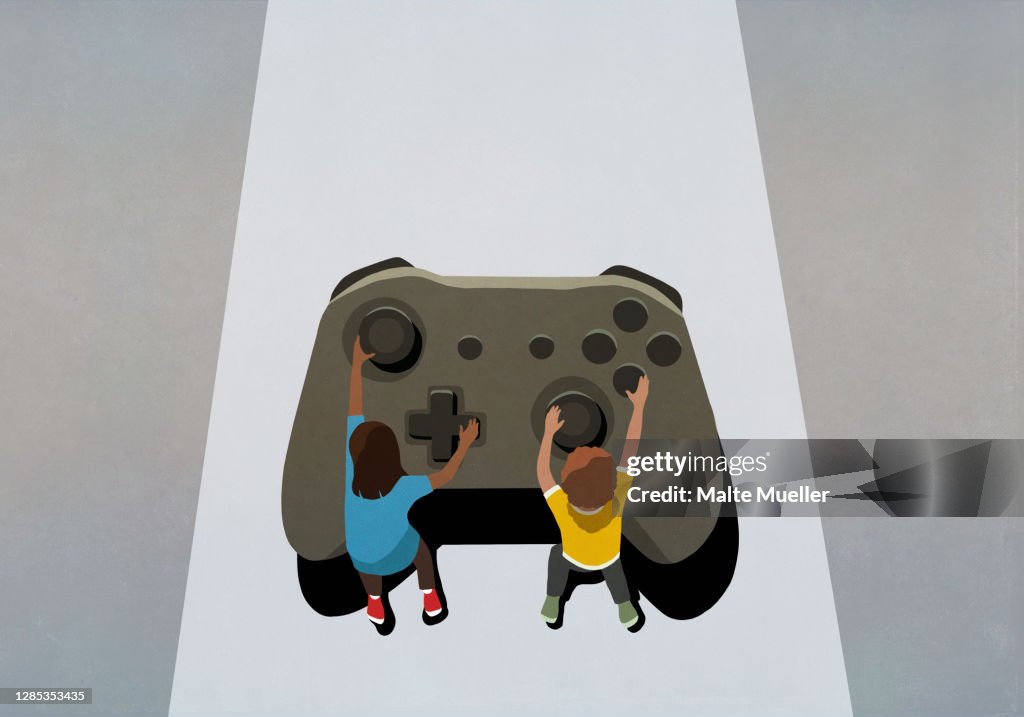 Boy and girl playing at large video game controller