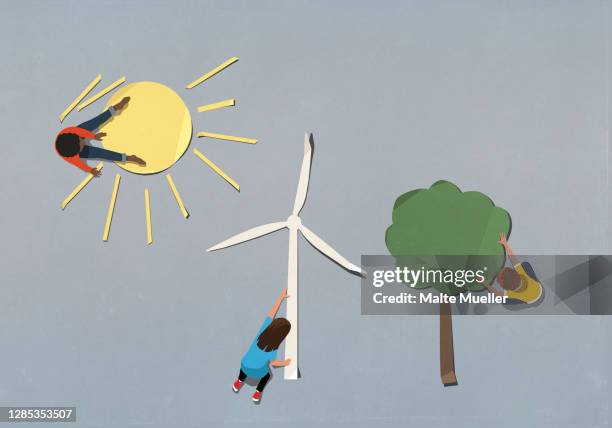 kids arranging environment and wind turbine paper symbols - renewable energy illustration stock illustrations