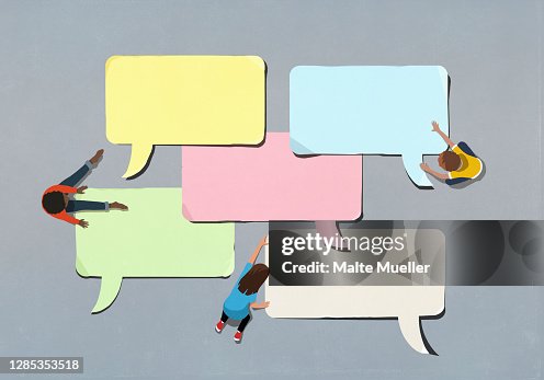 Kids arranging blank multicolor speech bubbles Kids arranging blank multicolor speech bubbles