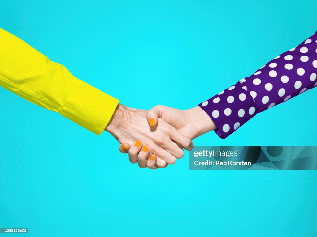 Vibrant handshake on turquoise background