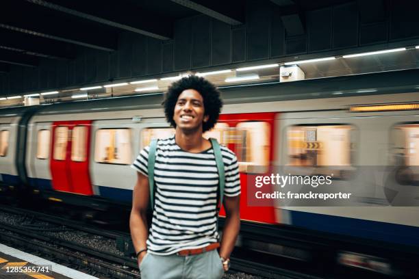 mens die de trein bij het station wacht - london underground train stockfoto's en -beelden