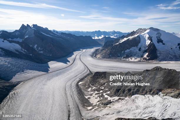 aerial flying over aletsch glacier in switzerland at sunrise - kanton wallis stock-fotos und bilder