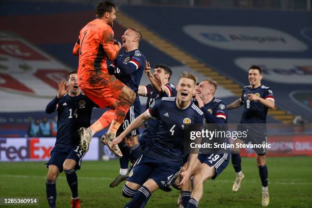 David Marshall of Scotland celebrates with Leigh Griffiths of Scotland and Scott McTominay of Scotland and his team as they celebrate after their...