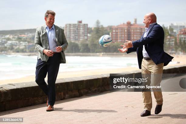 Rugby Australia interim Chief Executive Rob Clarke and New Zealand Rugby Chief Executive Mark Robinson pass a ball during a Rugby Australia and Rugby...