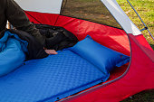 A close up of a blue camping inflating mattress pad