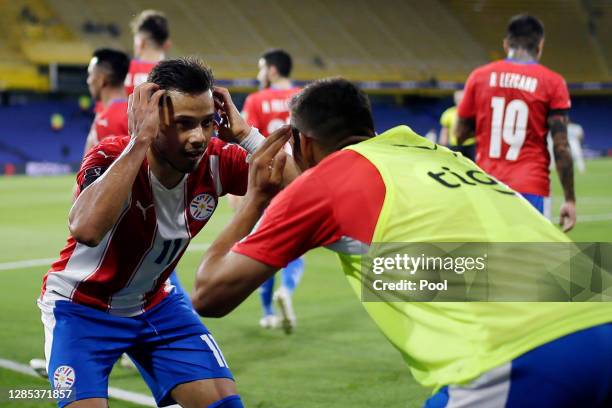 Ángel Romero of Paraguay celebrates after scoring the first goal of his team with teammate Óscar Romero during a match between Argentina and Paraguay...