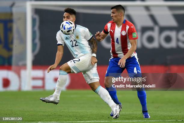 Lautaro Martínez of Argentina competes for the ball with Fabián Balbuena of Paraguay during a match between Argentina and Paraguay as part of South...