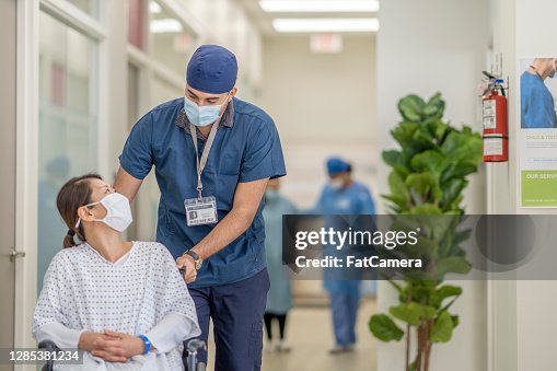 Masked male nurse and patient Masked male nurse and patient
