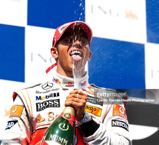 British McLaren Formula One driver Lewis Hamilton celebrates on the winners podium by spraying champagne after winning the 2009 Hungarian Grand Prix...