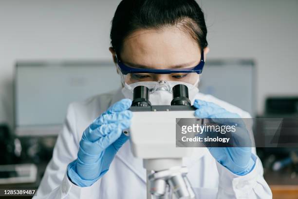 doctor working in hospital laboratory - research stock pictures, royalty-free photos & images