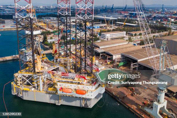 aerial view jack up rig for exploration oil in the sea, repairing in shipyard. - swamp gas stock pictures, royalty-free photos & images