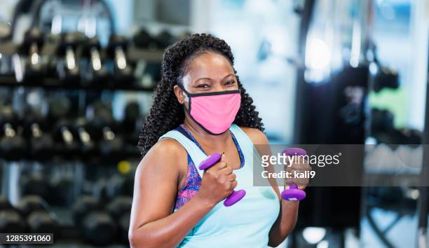 african-american woman at the gym, wearing face mask - health club stock pictures, royalty-free photos & images
