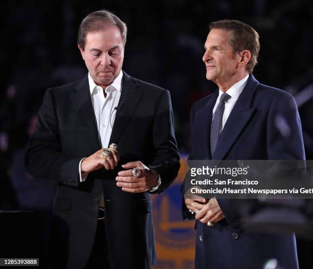 Golden State Warriors' owner Joe Lacob, left, admires at his three NBA Championship rings during the ring ceremony officiated by himself and co-owner...