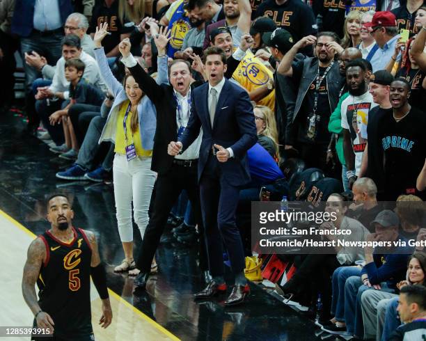 Golden State Warriors' owner Joe Lacob and general manager Bob Myers react to Kevin Durant's three-pointer late in the fourth quarter during game 3...
