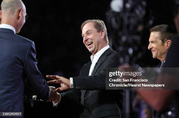 Golden State Warriors' owner Joe Lacob, center, receives his 2018 NBA Championship ring from NBA Commissioner Adam Silver during ceremony before...