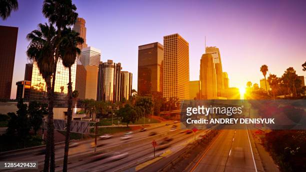 sunset. traffic. modern los angeles business district. - los angeles foto e immagini stock
