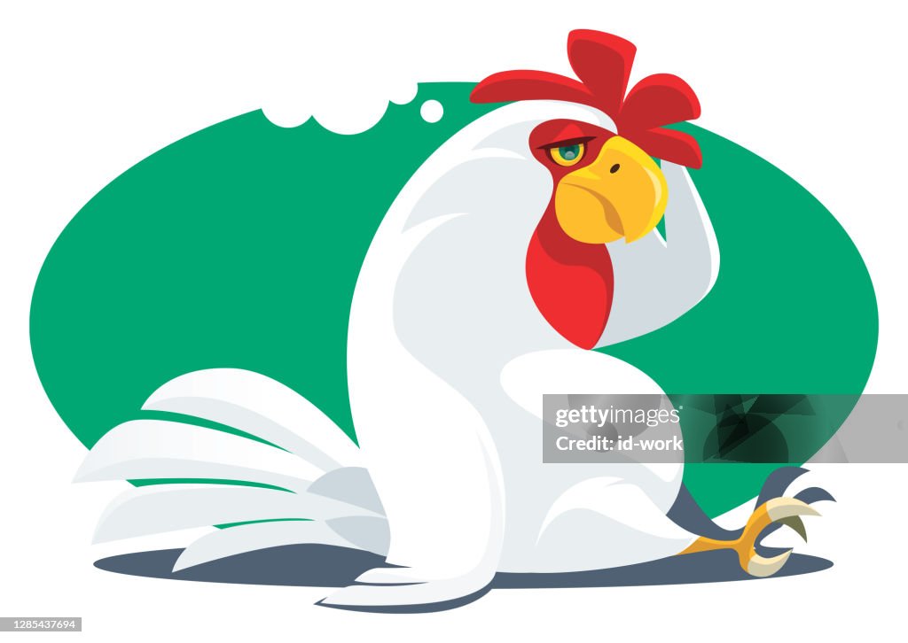 Tired rooster sitting and thinking