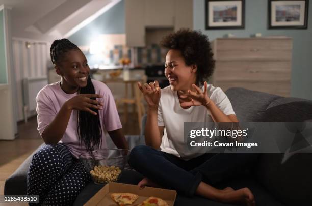 cheerful multiethnic girlfriends having pizza party - african american woman pajamas residential building stock pictures, royalty-free photos & images