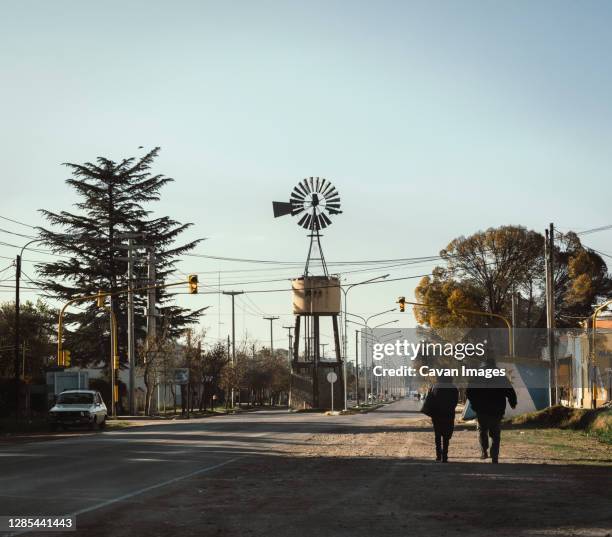 couple walked in a rural town with a mill on its main street - mendoza argentina fotografías e imágenes de stock