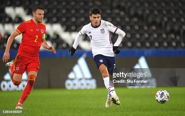 Player Giovanni Reyna beats Chris Gunter to the ball during the international friendly match between Wales and the USA at Liberty Stadium on November...