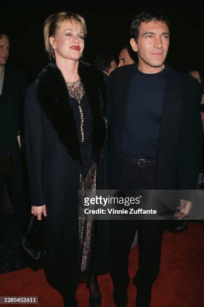 American actress Melanie Griffith and her husband, Spanish actor Antonio Banderas attend the premiere of 'Play It to the Bone' held at the El Capitan...