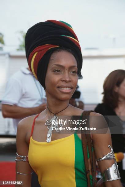 American singer-songwriter Erykah Badu, wearing a dress and matching headwrap in green, gold and red, attends the 4th Annual Soul Train Lady of Soul...
