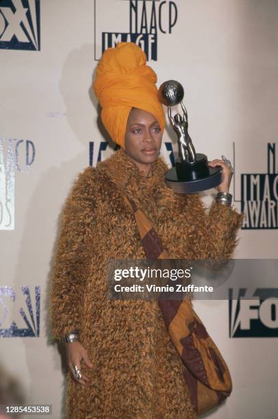 American singer-songwriter Erykah Badu wearing an orange headwrap attends the 29th Annual NAACP Image Awards, held at the Pasadena Civic Auditorium...