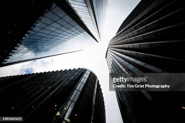 directly below shot of modern skyscrapers in the city of london - brexit uncertainty stock pictures, royalty-free photos & images