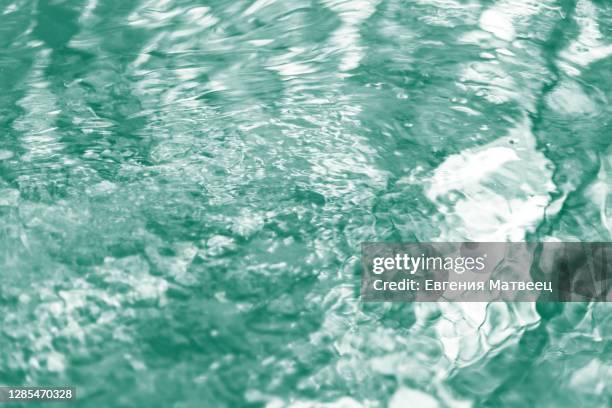 blurred water river abstract background with waves at surface toned ultramarine green - mint leaves stock pictures, royalty-free photos & images