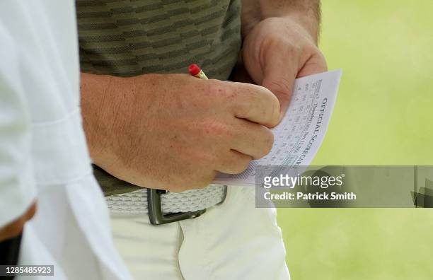 Detail as Rory McIlroy of Northern Ireland marks his scorecard on the 18th green during the continuation of the first round of the Masters at Augusta...