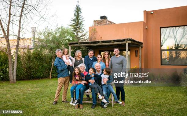 family organized group photo in the garden - organized group photo stock pictures, royalty-free photos & images