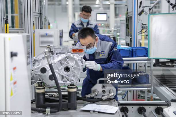 An employee works on the production line of APP310 electric drive at Volkswagen Automatic Transmission Co., Ltd on November 13, 2020 in Tianjin,...